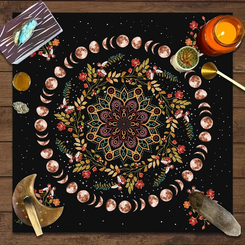 A dark mat featuring a circular design of crescent moons and floral elements for tarot readings.
