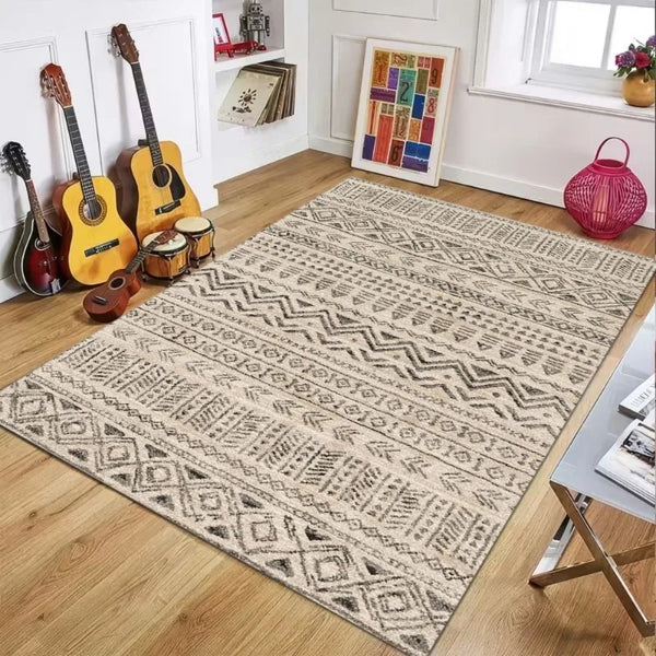 A rectangular beige and black patterned plastic straw rug placed on a wooden floor.