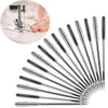 A collection of sharp metal sewing machine needles arranged in a fan shape.