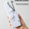 A hand is holding a white portable mini hand sewing machine with pliers and a needle visible.