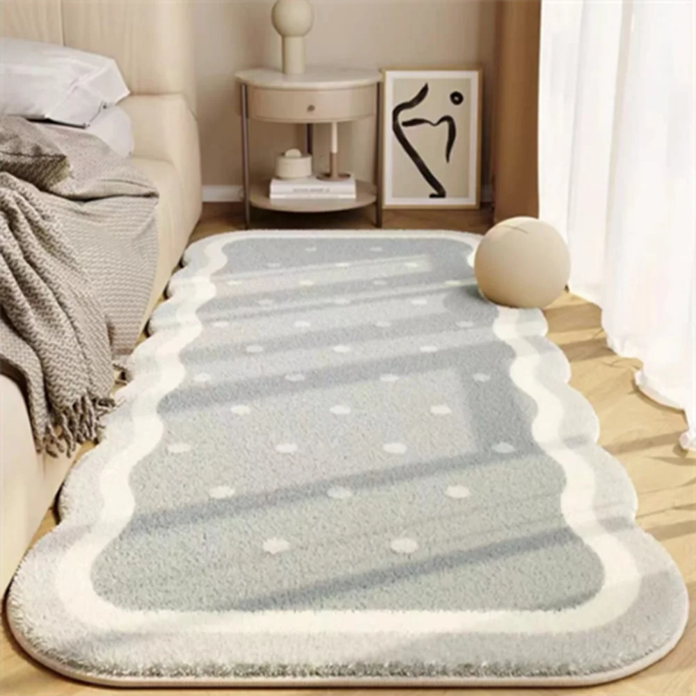 A rectangular light gray rug with white geometric patterns and dots placed on a wooden floor.