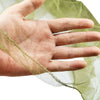 A hand is holding a sheer green mosquito net fabric over the palm.