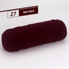 A skein of dark burgundy yarn labeled as Win Red, shown rolled up.