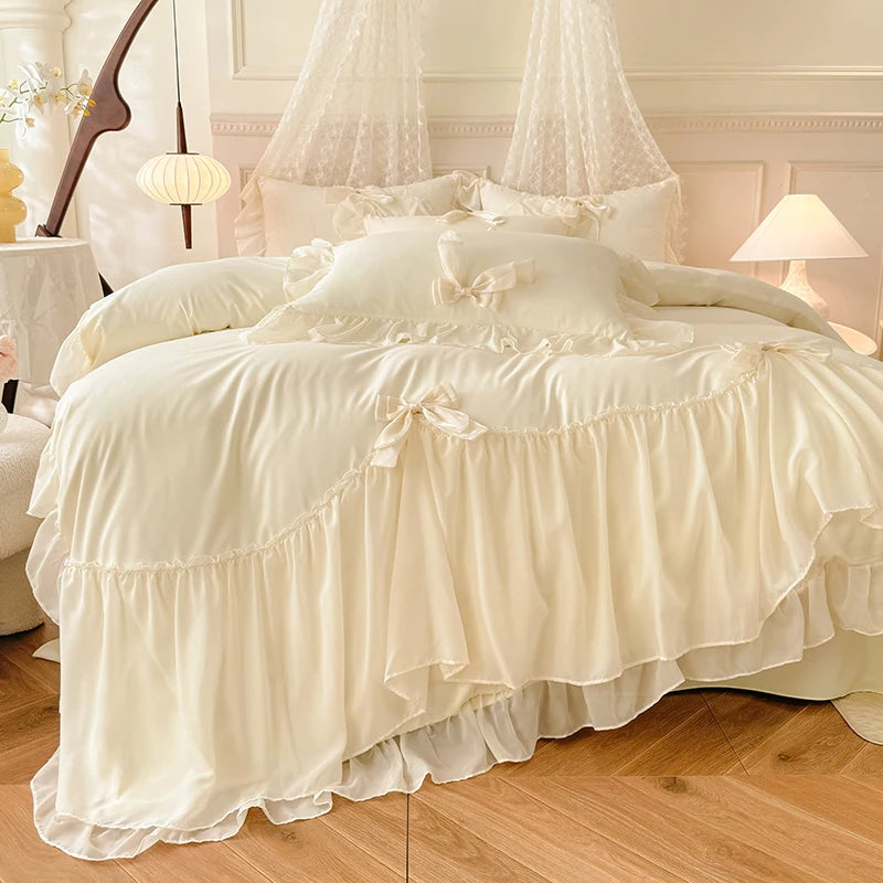 A luxurious cream princess chiffon duvet cover set displayed on a bed with sheer white curtains.