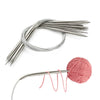 Stainless steel circular knitting needles set with a single pink yarn strand