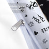 Close-up of a white fabric with black cat print and a silver hidden zipper closure detail.