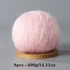 A spherical ball of pink mohair yarn used for crafting.
