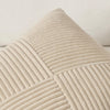A close-up of a beige textured corduroy throw pillow cover with vertical ribbing.