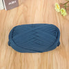 A ball of dark blue flat thread yarn for crafting and sewing resting on a wooden surface.