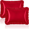 A set of two deep red ruffled satin pillowcases with silky envelope closures.