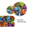 A colorful print of various dinosaurs on a flannel throw blanket.