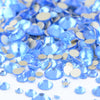 A pile of clear blue and silver glass rhinestones for DIY crafts