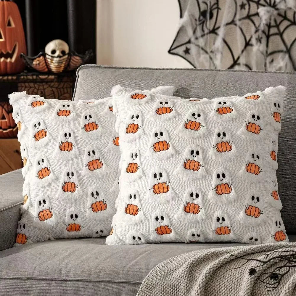 White throw pillow cover featuring an all-over pattern of orange ghost and pumpkin faces