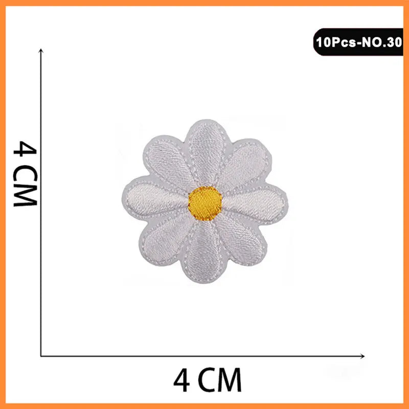 A set of 10 embroidered iron-on patches featuring a white flower design with a yellow center.