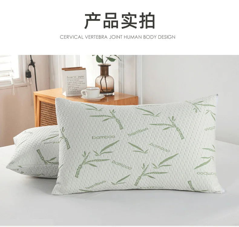 A close-up of a light green bamboo patterned pillow protector resting on a white surface.
