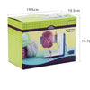 A box of yarn winder with a purple ball winding mechanism and green polka dot packaging.