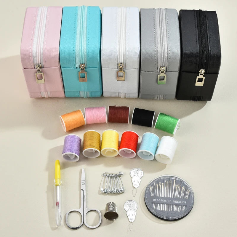 A collection of colorful leather sewing boxes and a complete hand sewing kit including needles and scissors.
