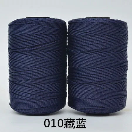 Two spools of dark blue hand knitting and crochet cord for crafting