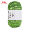 A ball of metallic green T-shirt yarn for crochet and DIY crafts