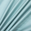 Soft mint green bamboo flat sheets draped and folded to show fabric texture