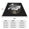 A dark blanket featuring a silhouette of a dragon against a moonlit background.