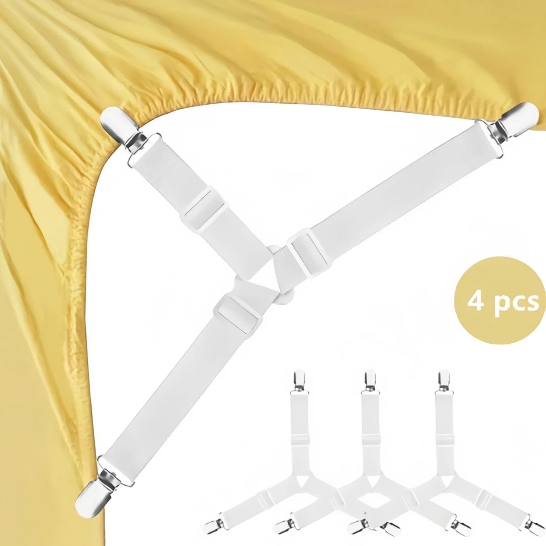 A set of four white adjustable triangle bed sheet clips used to secure bedding.