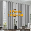 Four panels of gray blackout curtains hanging in a window frame.