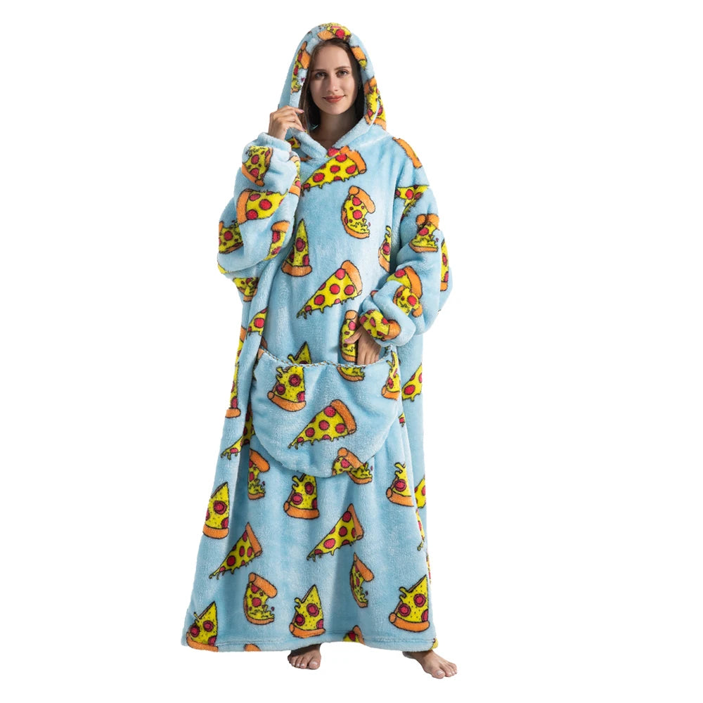 A woman wearing a blue sherpa fleece oversized blanket hoodie with a yellow and orange food pattern.