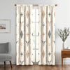 Light beige curtains featuring a repeating pattern of stylized bull skulls and geometric tribal motifs.