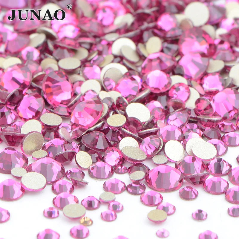 A pile of pink and clear glass rhinestones for DIY crafts