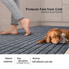 A golden retriever lies on a gray striped runner rug protecting its feet from the cold.