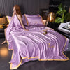 A luxurious purple ice silk blanket set is displayed on a bed with gold accents and green foliage in the background.