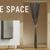 A close-up view of a black magnetic accordion pleated door curtain hanging in a modern bathroom or closet setting.