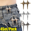A set of four adjustable star-shaped metal buttons for clothing shown on denim fabric.