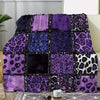 A luxury plush flannel throw blanket featuring vibrant purple and black leopard print stitching.