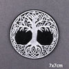 Black and white embroidered skull patch featuring intricate foliage design on a circular background