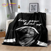 A black throw blanket featuring a black and white portrait of a man with a headband and the text keep your head up