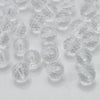 A close-up view of clear, faceted glass beads in various sizes and shapes for jewelry making.