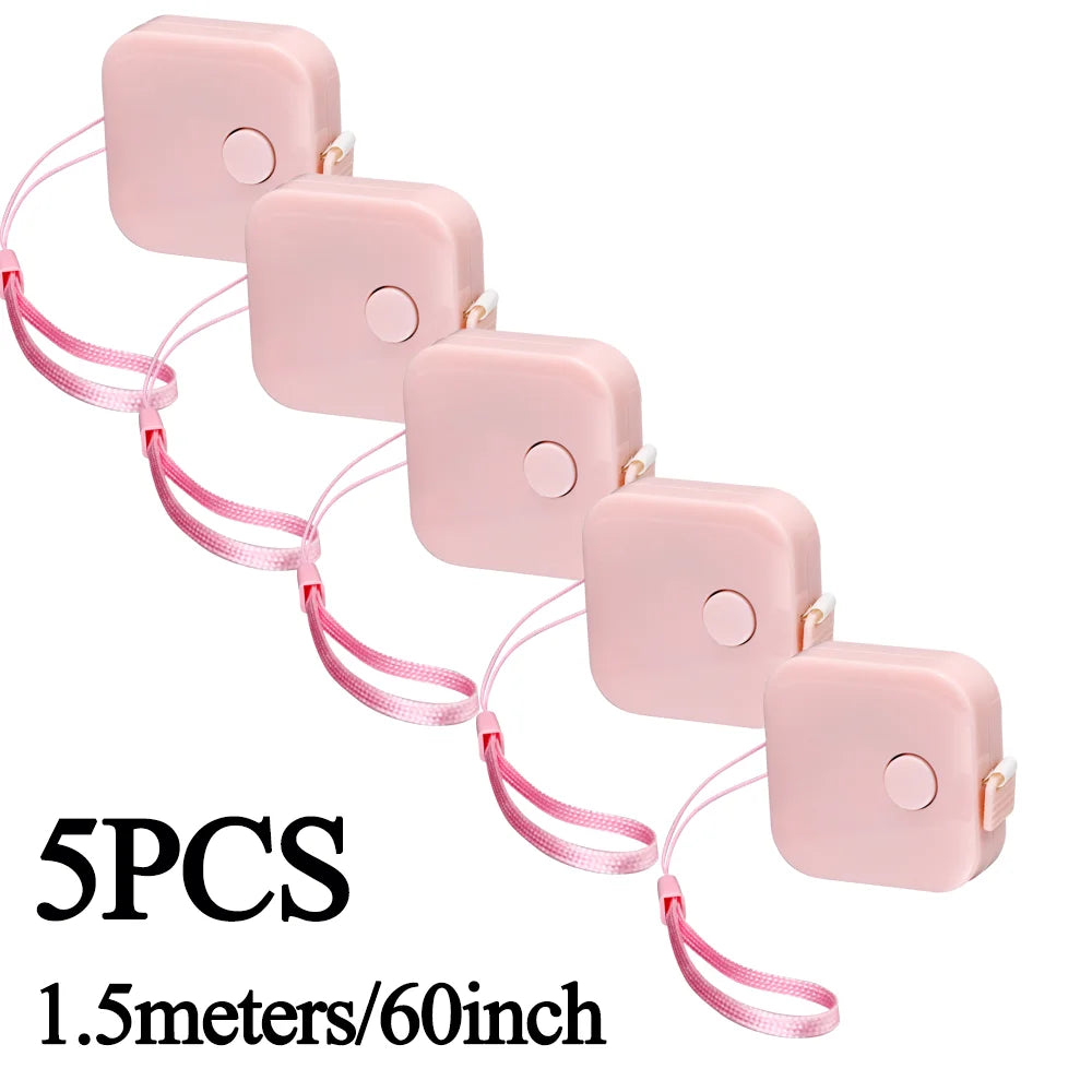 Five pink retractable measurement tapes with pink cords shown against a white background.