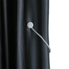 Silver magnetic curtain tieback attached to a dark gray fabric curtain.