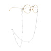 Gold-rimmed round eyeglasses with a delicate silver chain featuring small star and moon charms
