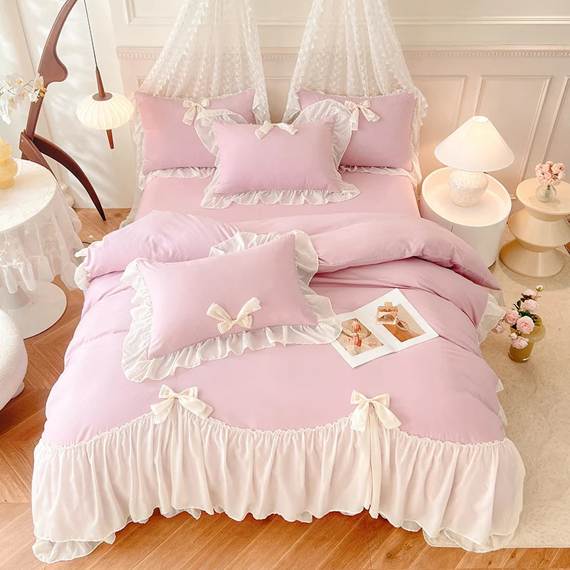 A pink and white princess chiffon duvet cover set displayed on a bed with sheer fabric canopy.