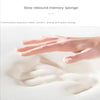 A hand is pressing into a white memory sponge or foam material to demonstrate pressure relief and suction.