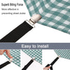 Close-up of a black non-slip bed sheet clip and holder attached to a green plaid fabric.