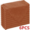 A stack of six rust-colored, fluffy decorative cloth napkins.