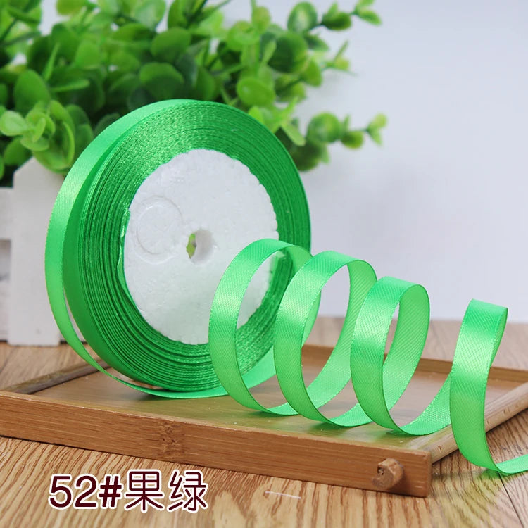 Roll of bright green satin ribbon for crafting or decoration