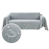 A gray waterproof sofa cover blanket draped over a sofa.