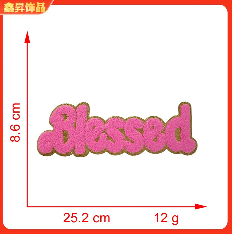 Pink embroidered patch with the word Blessed on a white background