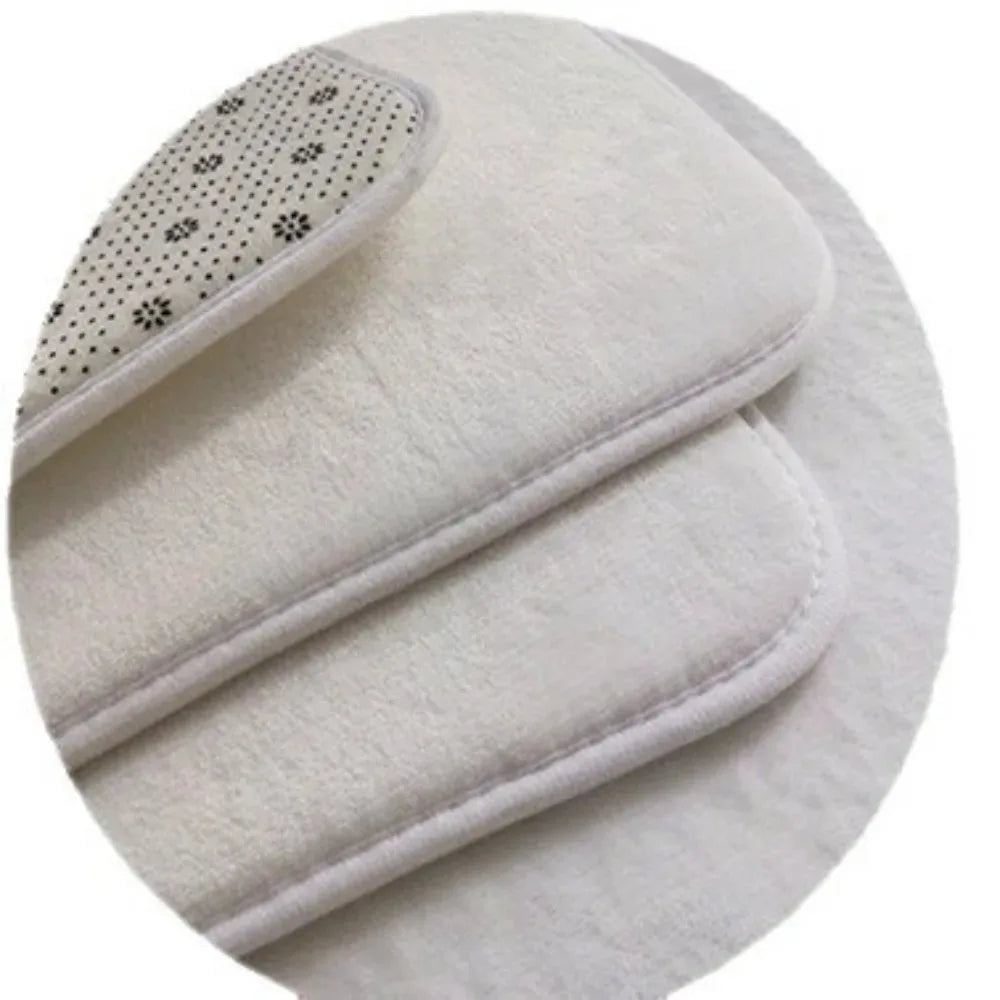 A white, fluffy indoor rug with a decorative pattern on the edge.