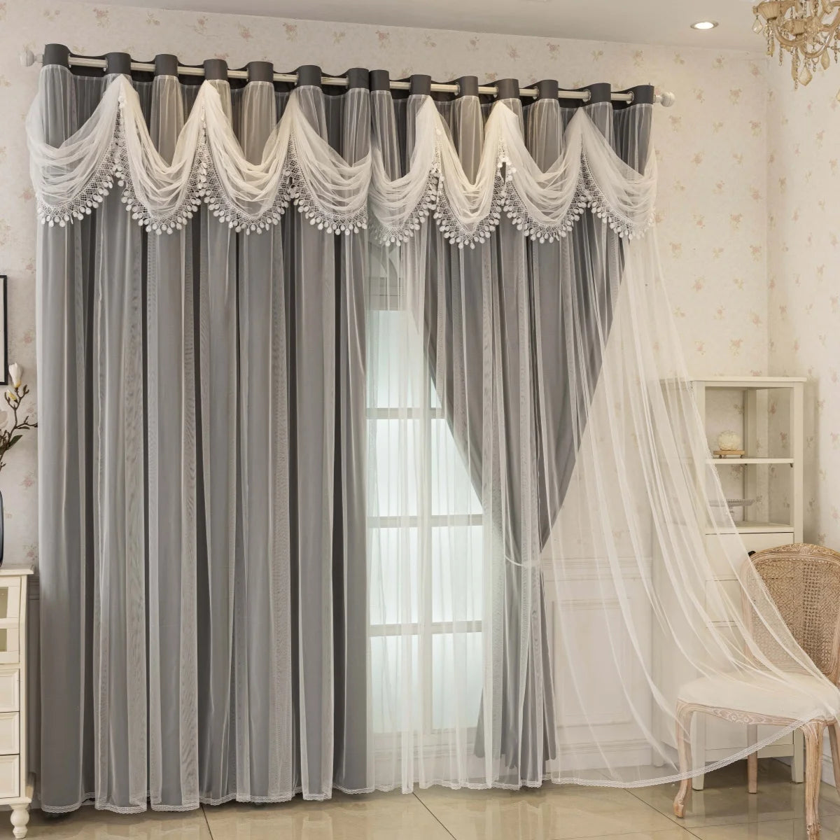 Gray blackout curtains with white wave pattern detail hanging in a window.
